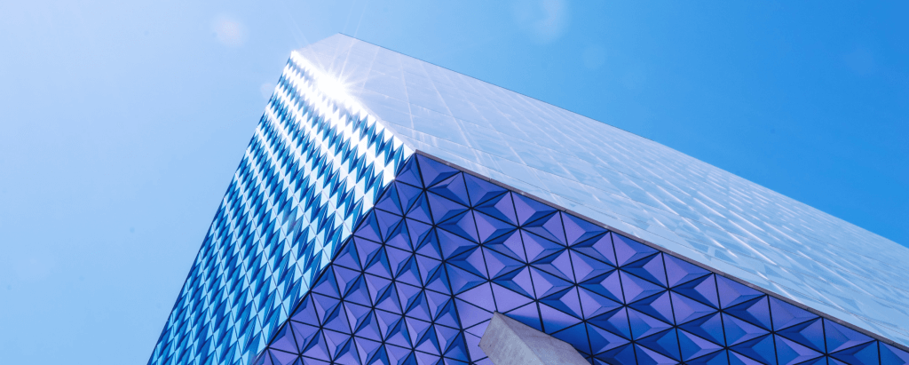 An image of a building with blue and purple glass.