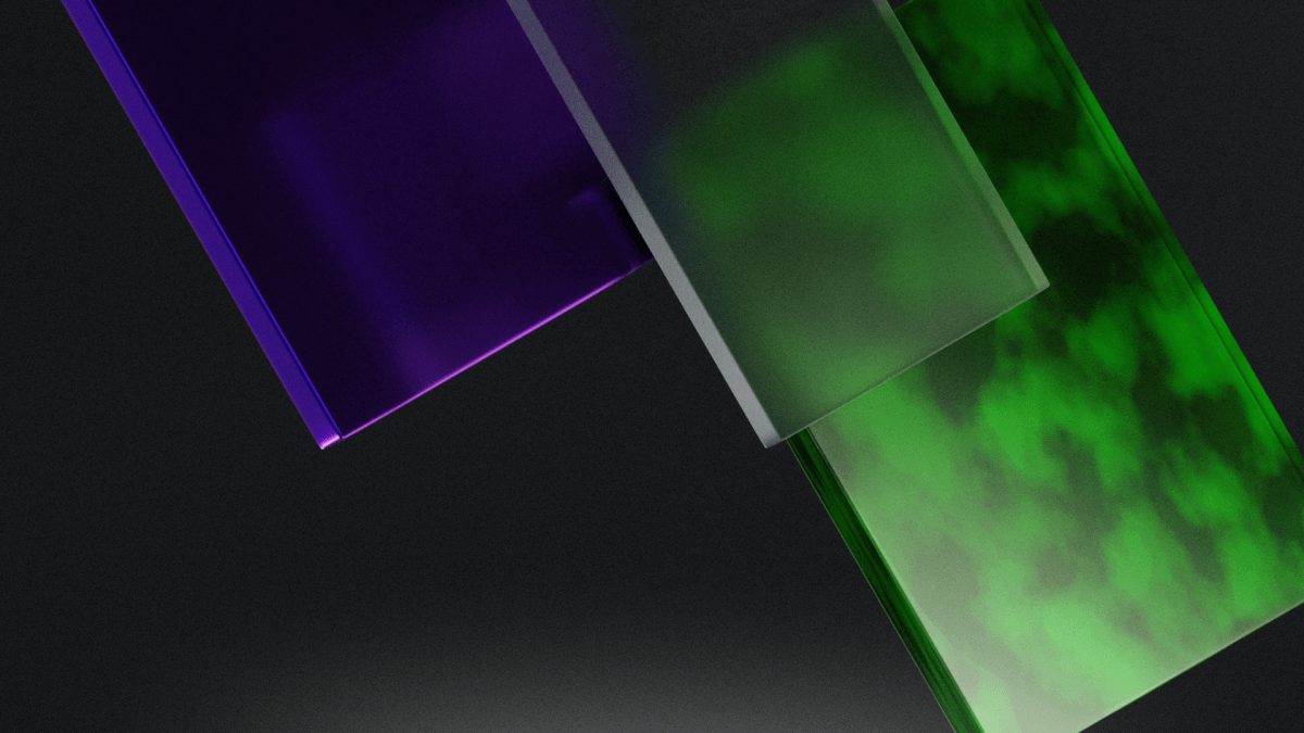 A glass sheet with green, purple, and blue colors against a black background.